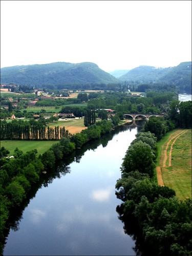 The Dordogne river stretches off into a fairy-tale landscape of bridges, chateaux and mist-covered mountains.