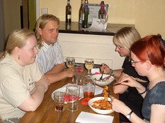 Tytti and Jani sitting at a table; Kaisa and Maarit eating.